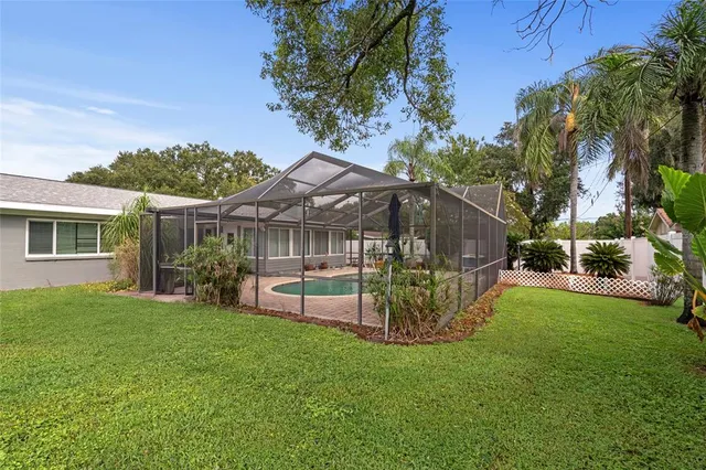 an aerial view of a house with yard swimming pool and outdoor seating