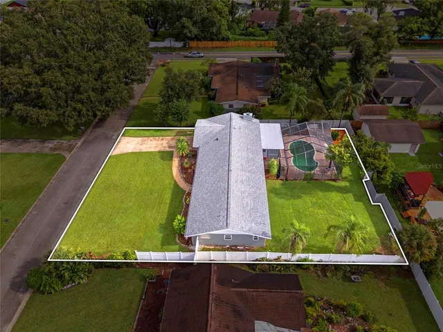 an aerial view of a house with a yard