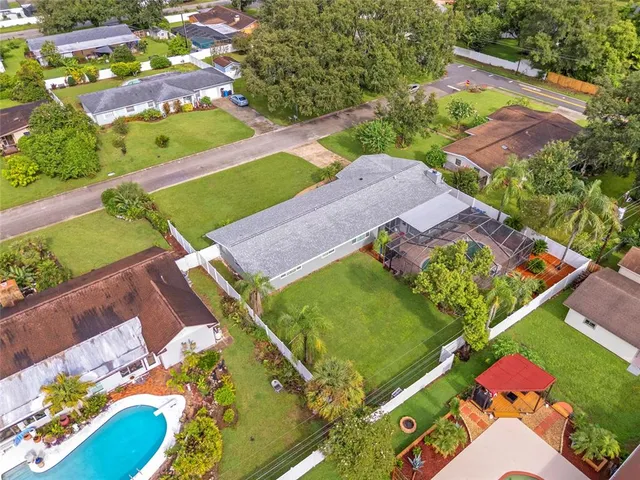 an aerial view of a house with a swimming pool