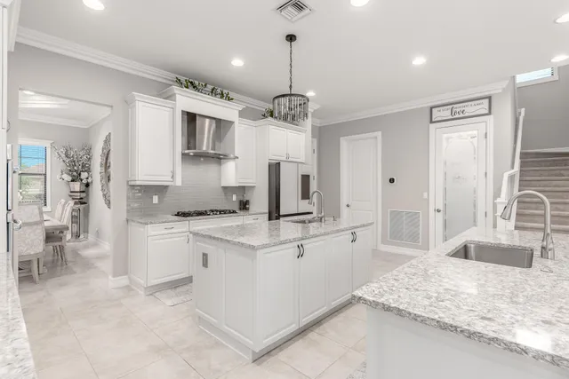 a large kitchen with stainless steel appliances kitchen island granite countertop a sink and cabinets