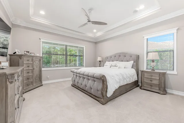 a bathroom with a granite countertop bathtub a sink and a large mirror