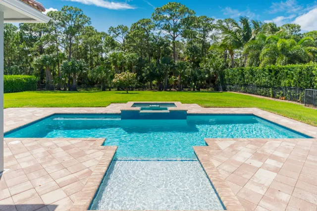 a view of swimming pool with umbrella