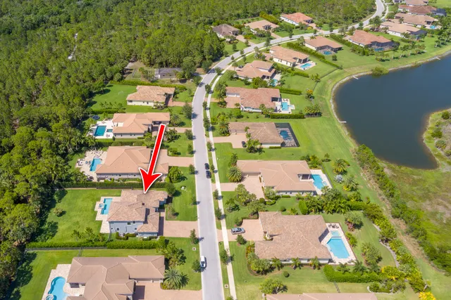 an aerial view of residential house with outdoor space and swimming pool