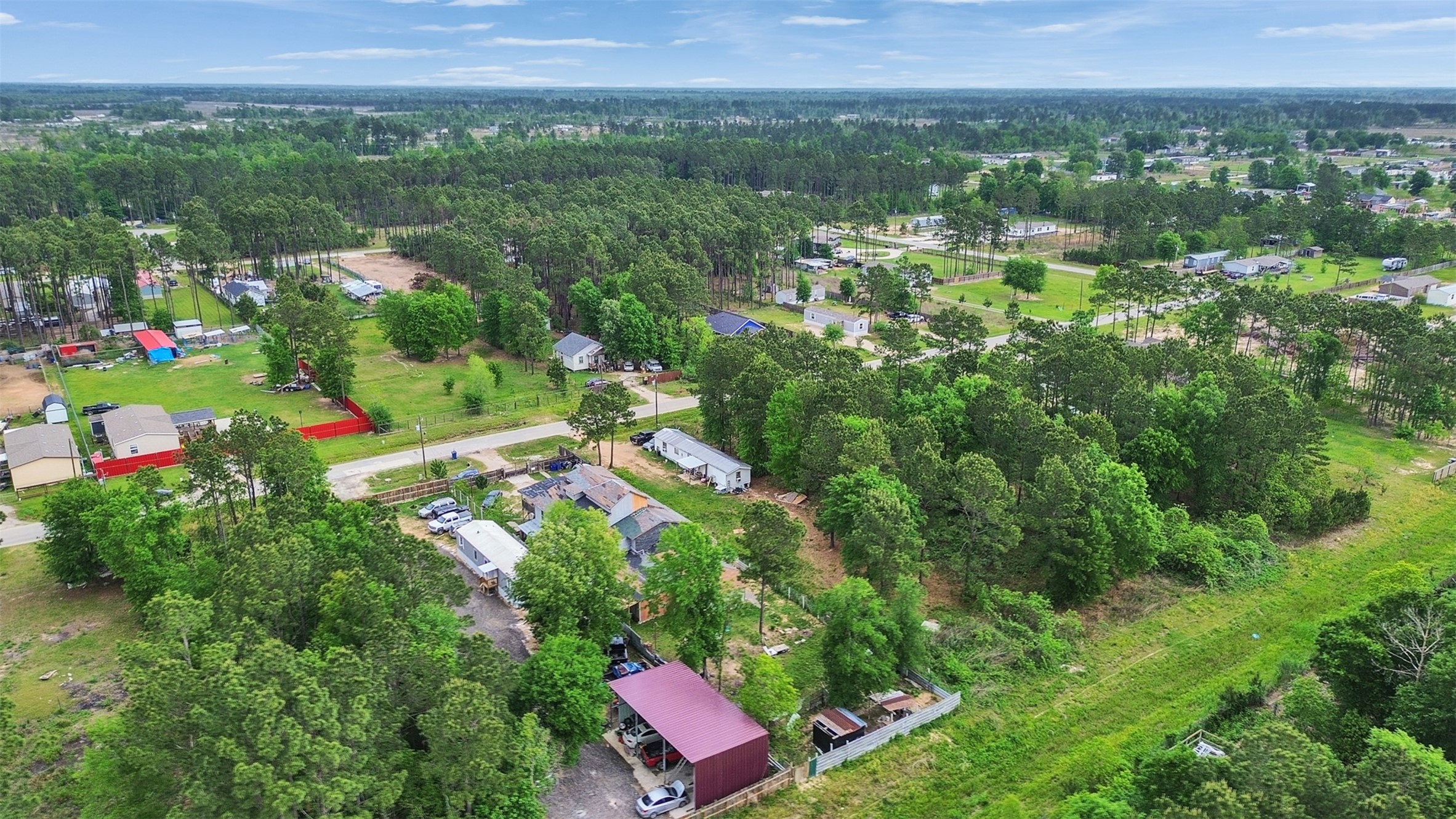 137 County Road 5023 Cleveland, TX 77327 - Photo 5 of 49 a view of a city with lush green forest