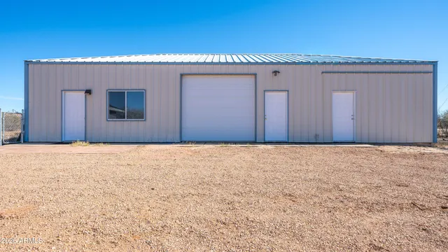 a large kitchen with stainless steel appliances granite countertop a large counter top and wooden floors