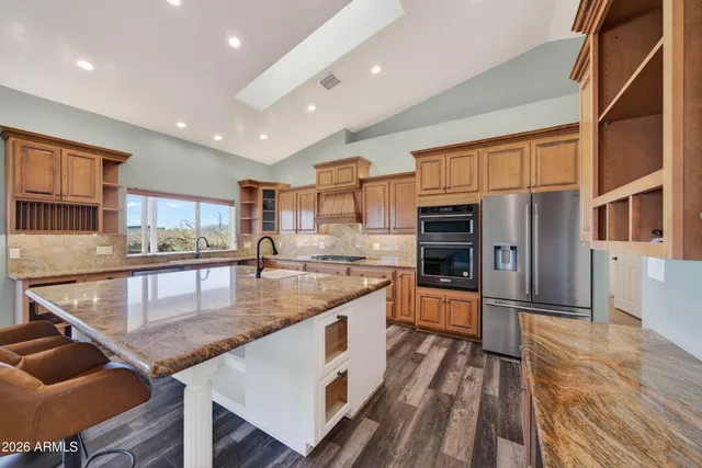 a large kitchen with a table and chairs