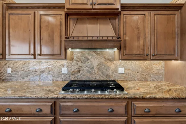 an empty room with wooden floor and fan