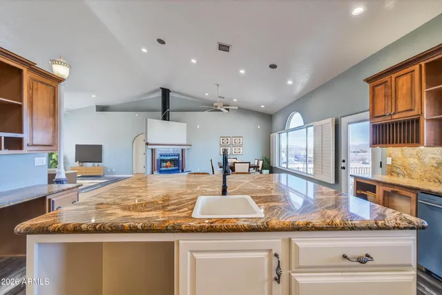a spacious bedroom with a bed and a chandelier