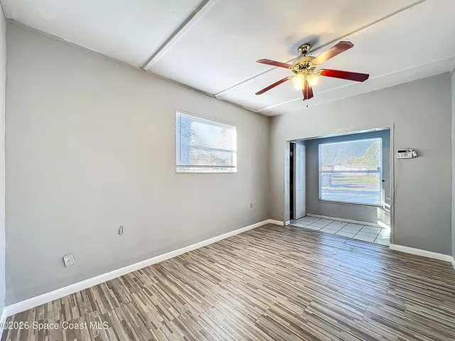 wooden floor in an empty room with a window