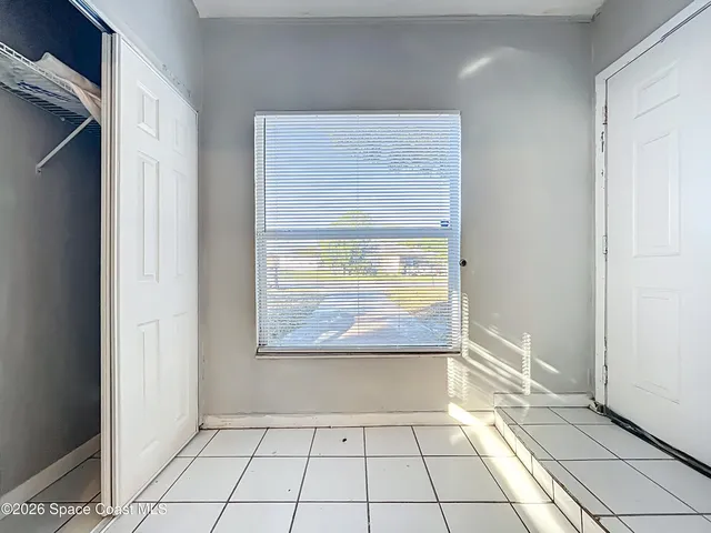 a view of a room with wooden floor