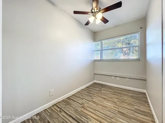 a view of a room with wooden floor