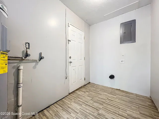 a view of a yard with plants and trees