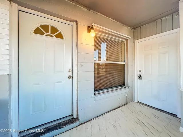 a view of an entryway door with wooden floor