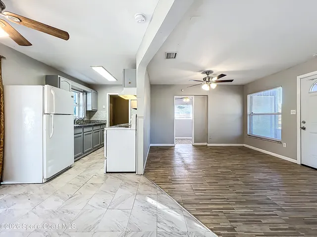 a view of a kitchen with a refrigerator a stove top oven and a refrigerator
