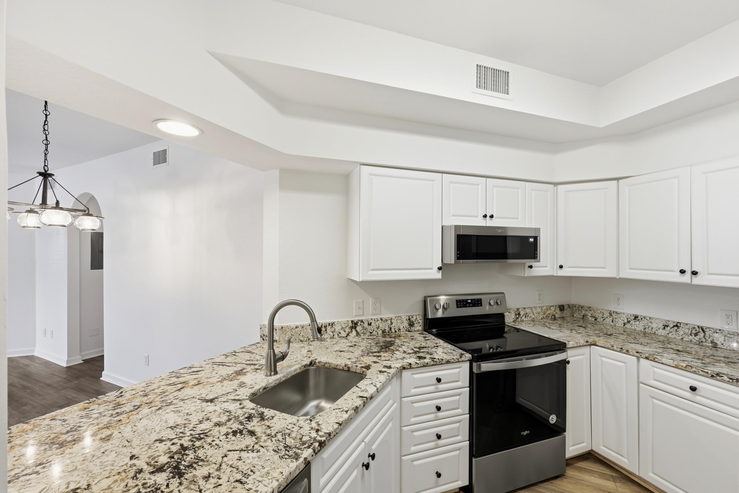 2500 Vista Cove Road St. Augustine, FL 32084 - Photo 8 of 53 a kitchen with stainless steel appliances granite countertop a stove a sink and a microwave