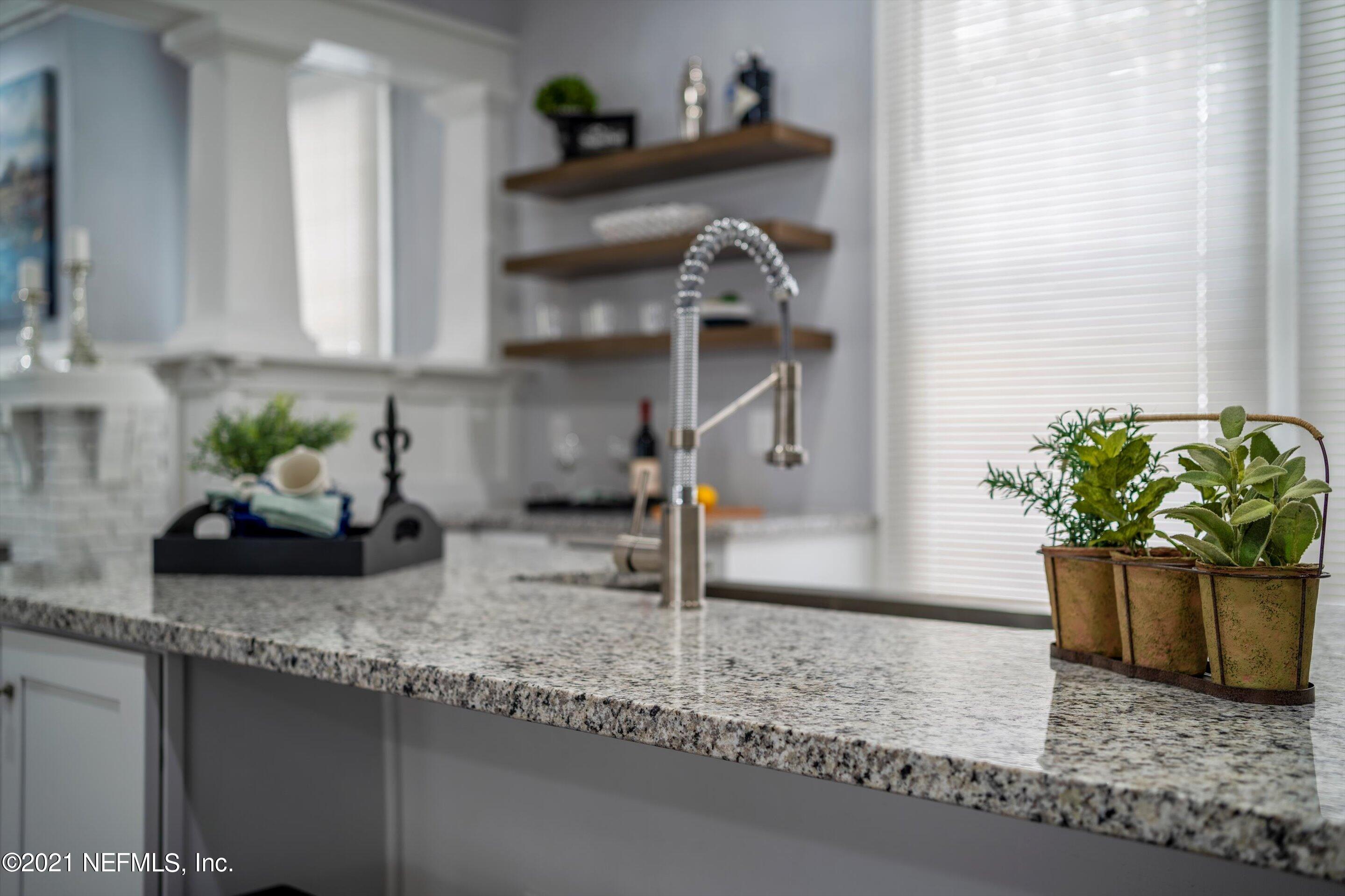 310 West 10th Street Jacksonville, FL 32206 - Photo 20 of 34 a kitchen with a sink a counter and cabinets