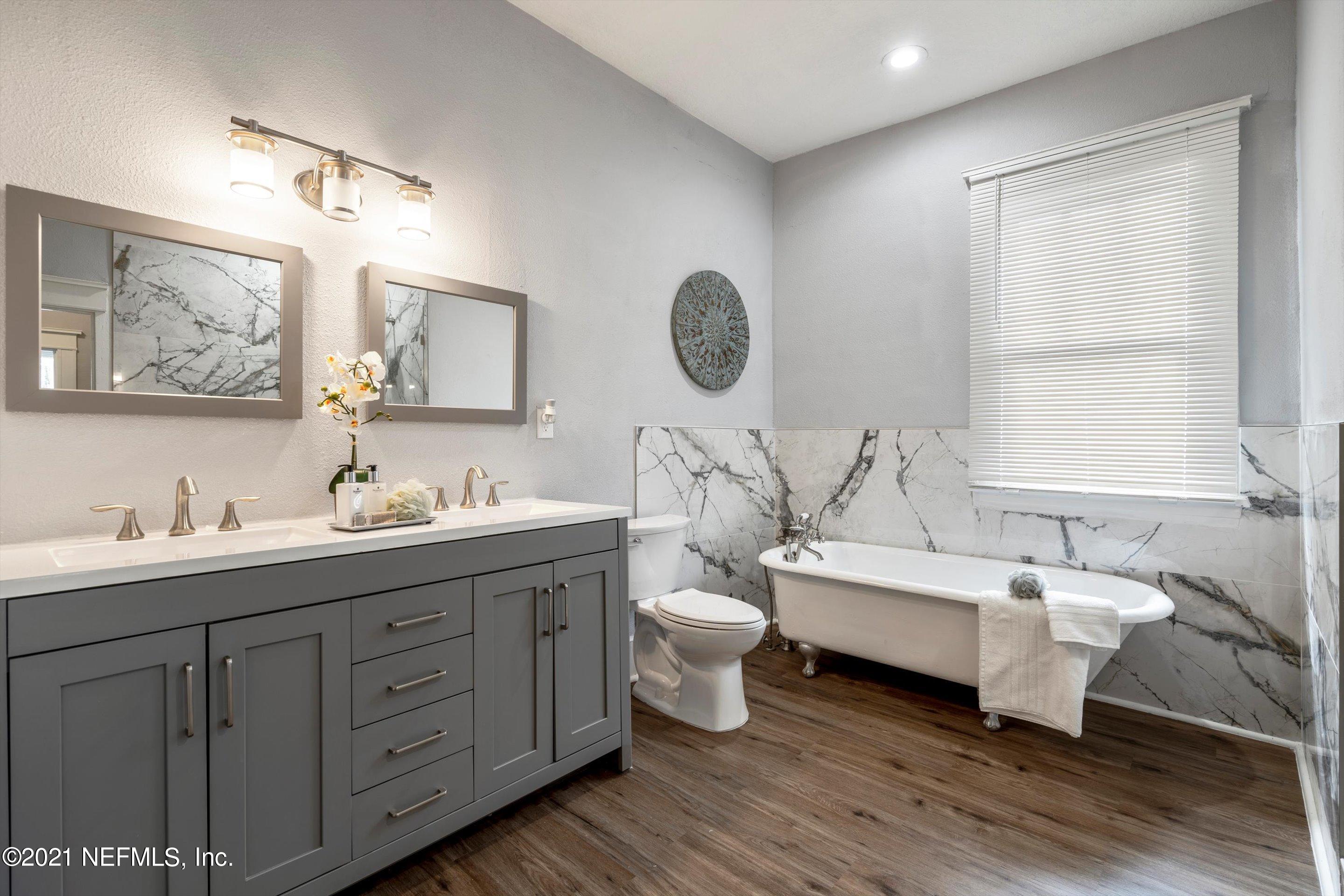 310 West 10th Street Jacksonville, FL 32206 - Photo 27 of 34 a spacious bathroom with a double vanity sink a mirror and a toilet
