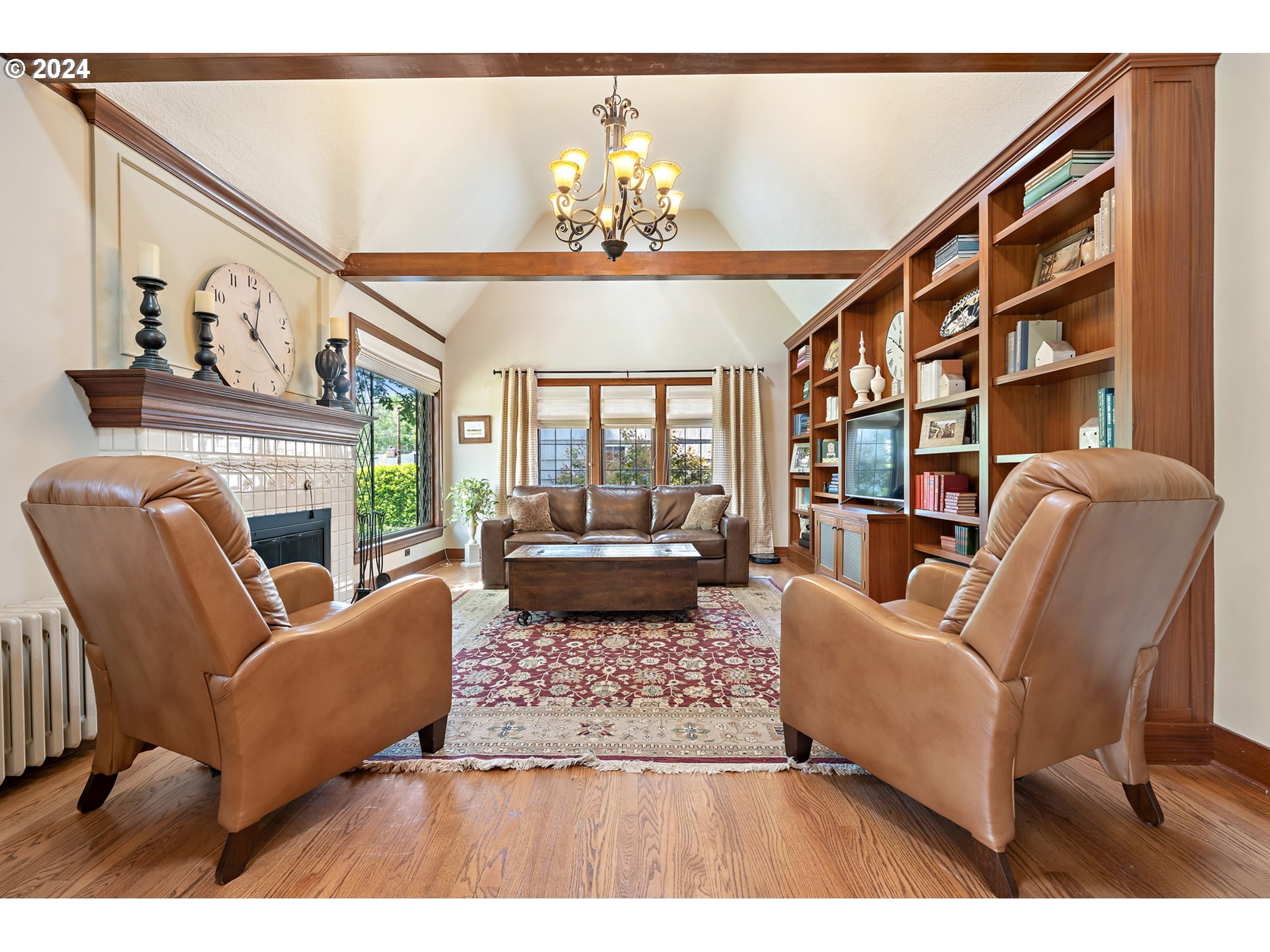 3433 Southeast Henry Street Portland, OR 97202 - Photo 5 of 48 a living room with furniture a fireplace and a chandelier