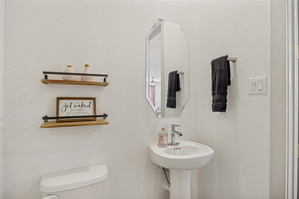 1650 Jessica Lane Allen, TX 75002 - Photo 12 of 25 a bathroom with a sink a mirror and toilet