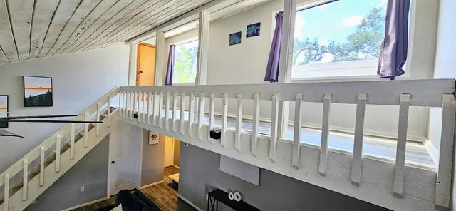 a view of a balcony dining area with furniture window wooden floor and garden
