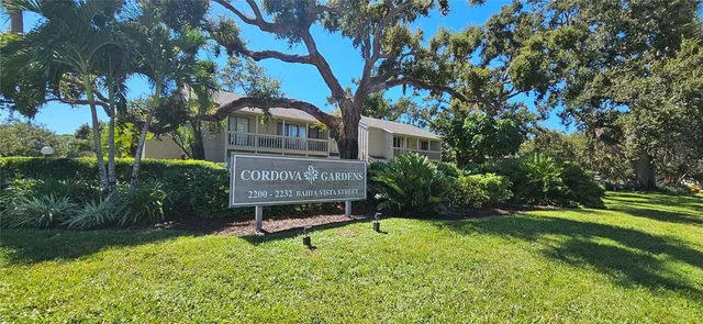 a view of a house with a yard and sitting area