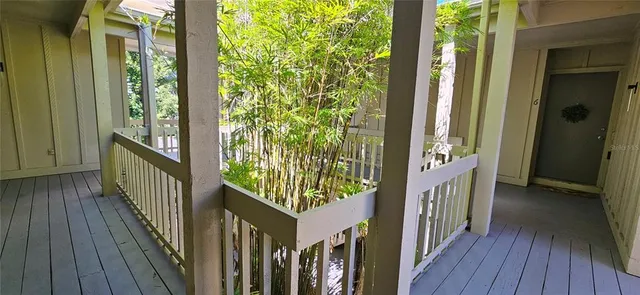 a view of a porch with wooden floor and stairs