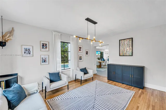 a living room with furniture a rug and a window