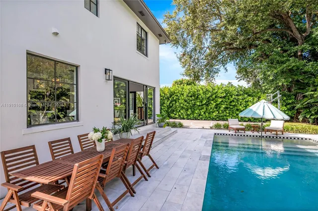 a view of a patio with table and chairs and potted plants with wooden floor