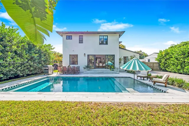 a view of a backyard with a patio and fire pit