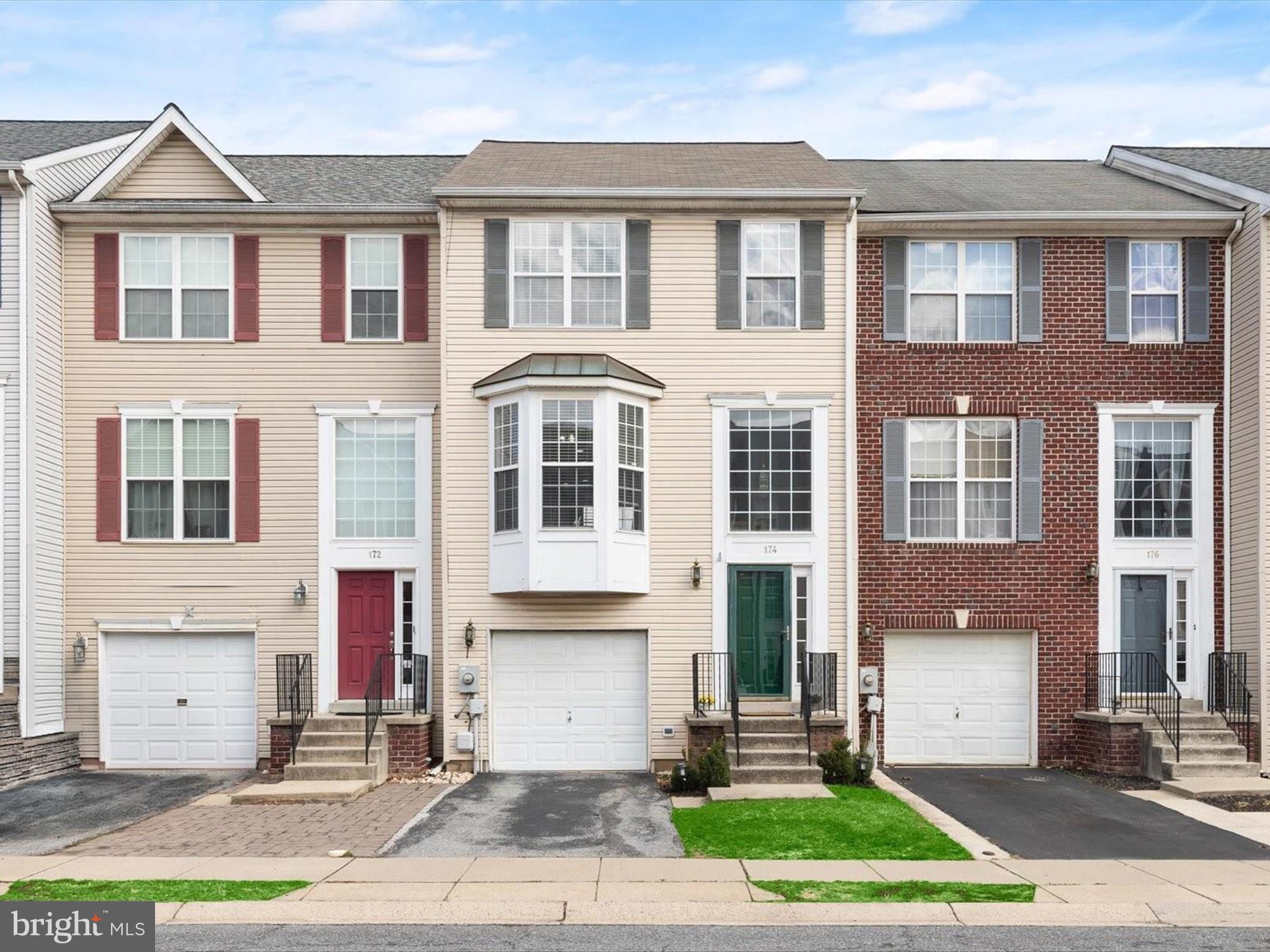 174 Harpers Way Frederick, MD 21702 - Photo 1 of 56 a front view of a house with a yard and garage