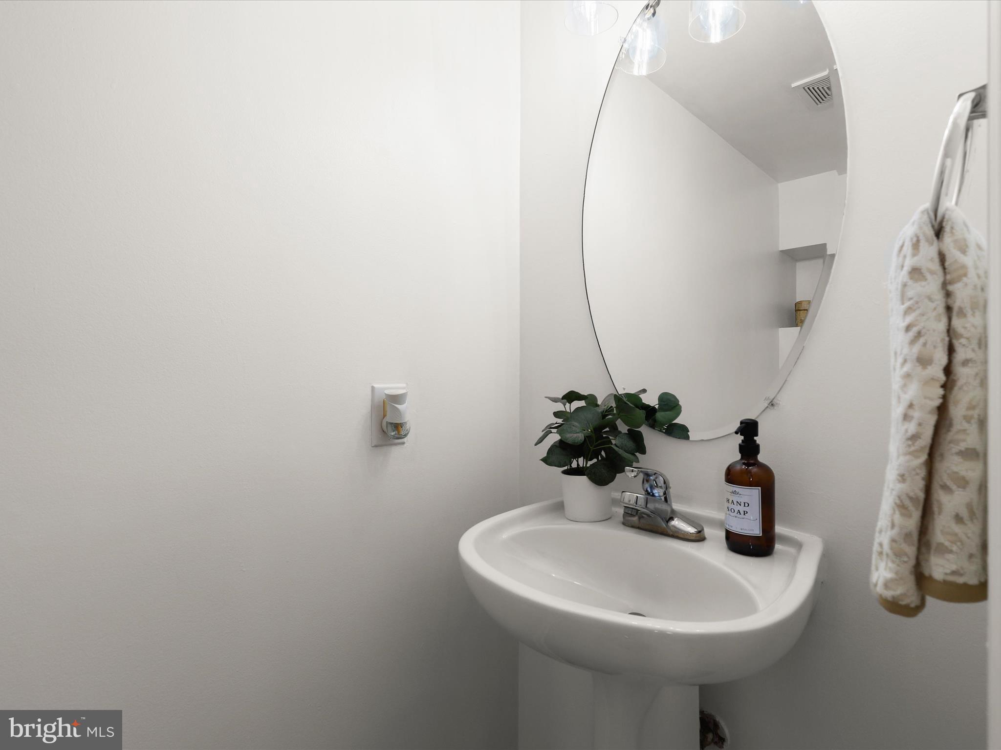 174 Harpers Way Frederick, MD 21702 - Photo 15 of 56 a bathroom with a sink a mirror and vanity