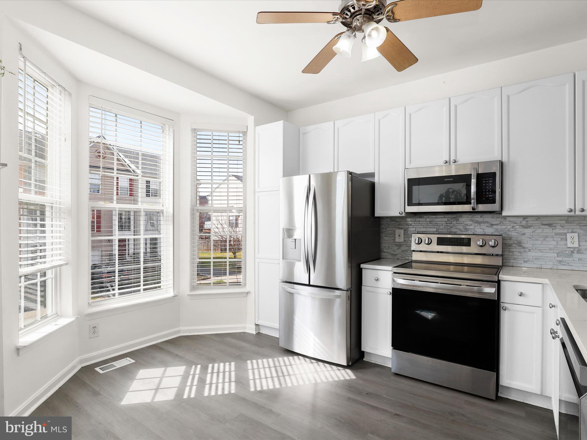 174 Harpers Way Frederick, MD 21702 - Photo 2 of 56 a kitchen with stainless steel appliances granite countertop a refrigerator a stove a sink and a microwave