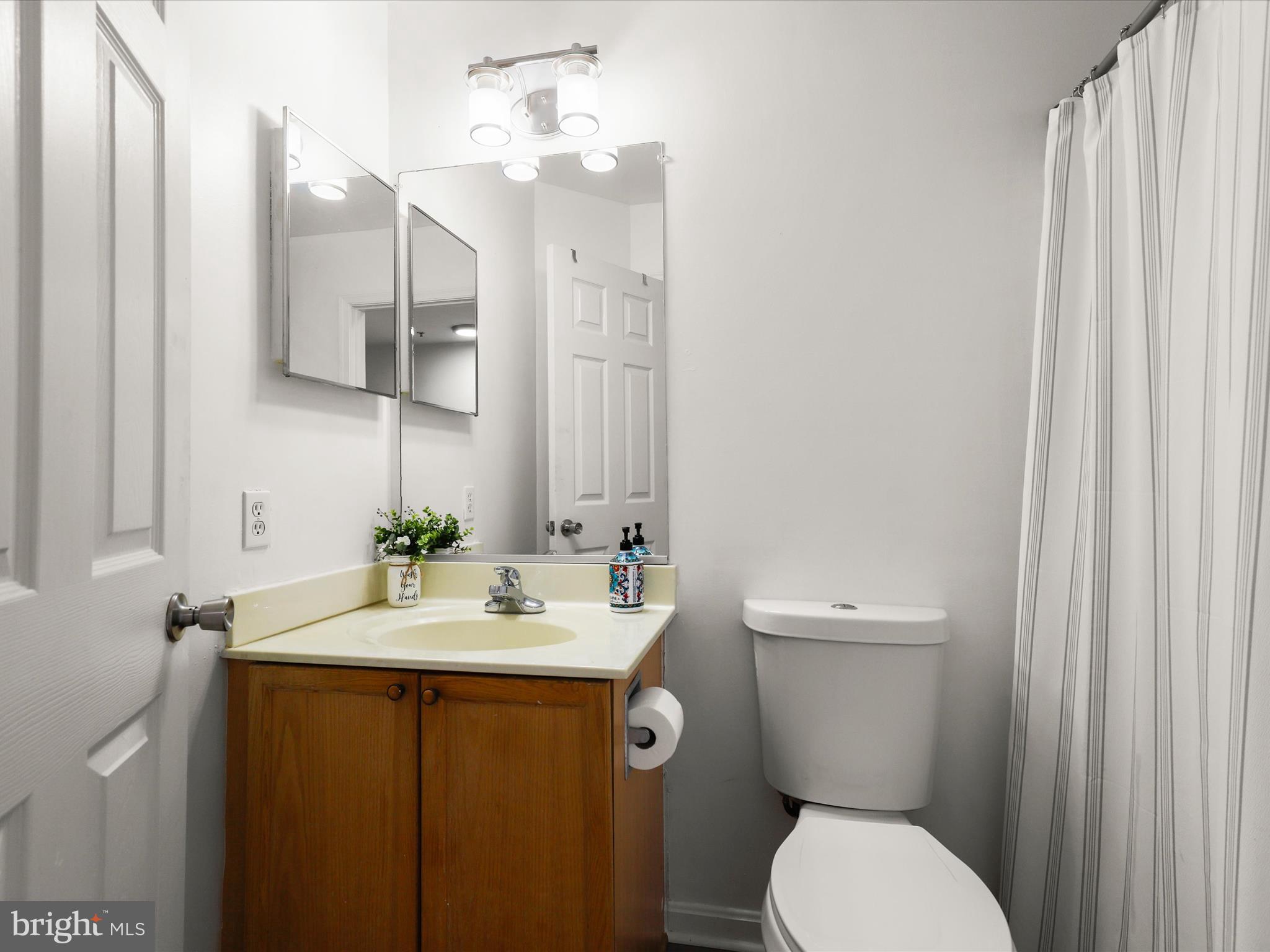 174 Harpers Way Frederick, MD 21702 - Photo 23 of 56 a bathroom with a granite countertop toilet sink and mirror