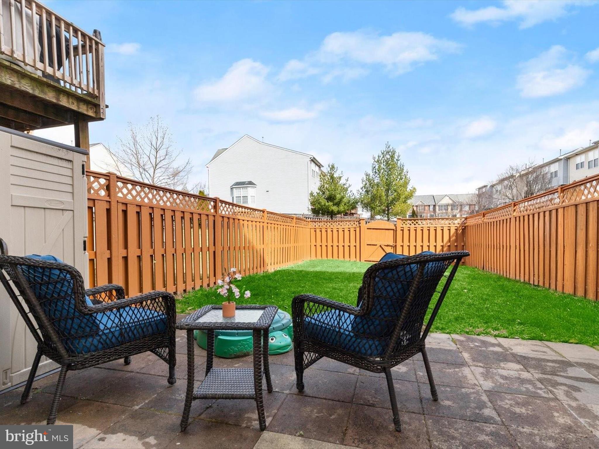 174 Harpers Way Frederick, MD 21702 - Photo 30 of 56 a view of a chairs and table in the back yard of the house