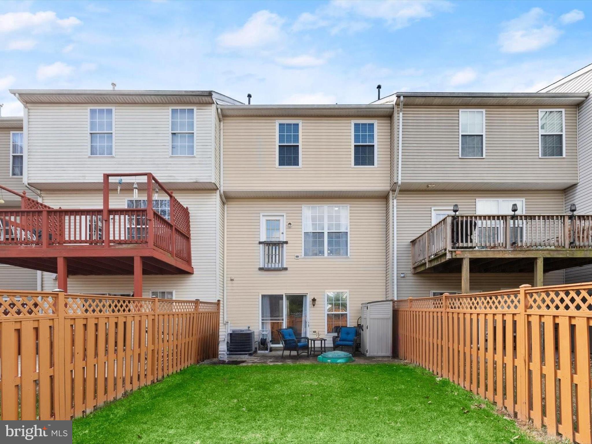 174 Harpers Way Frederick, MD 21702 - Photo 32 of 56 a view of a house with wooden deck and a yard