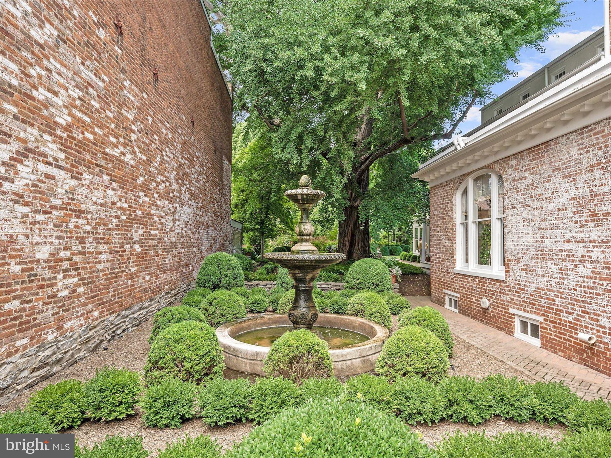 174 Harpers Way Frederick, MD 21702 - Photo 49 of 56 a view of a garden with a fountain