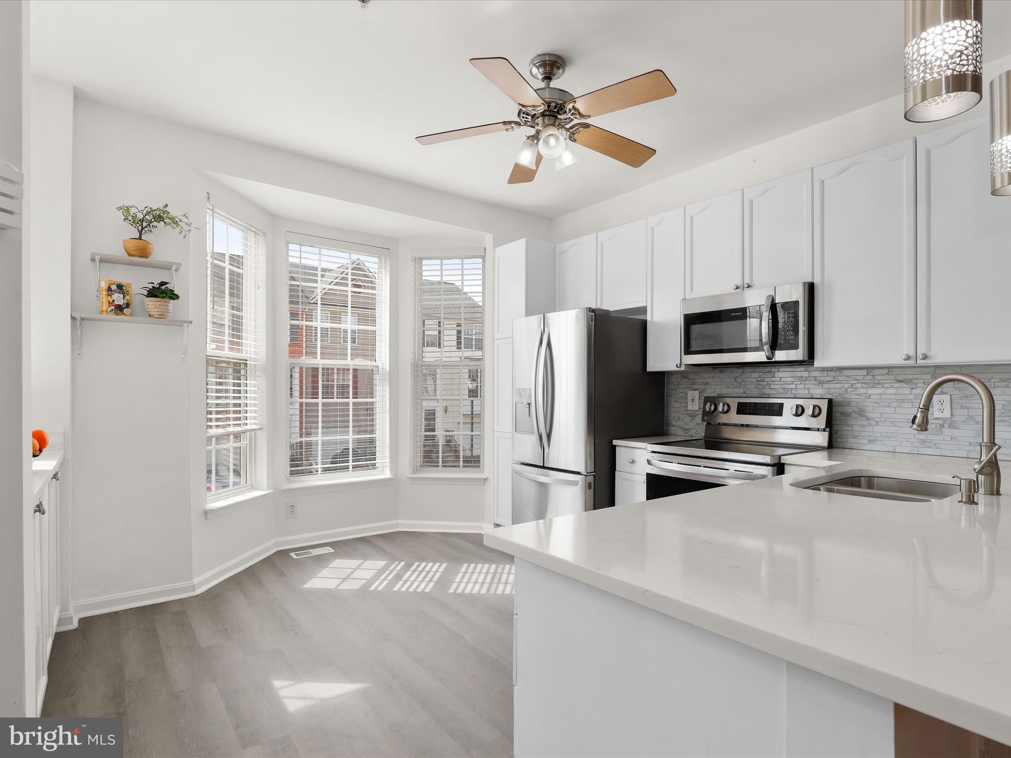 174 Harpers Way Frederick, MD 21702 - Photo 7 of 56 a kitchen with stainless steel appliances granite countertop a sink a stove a microwave a refrigerator a cabinets and a window