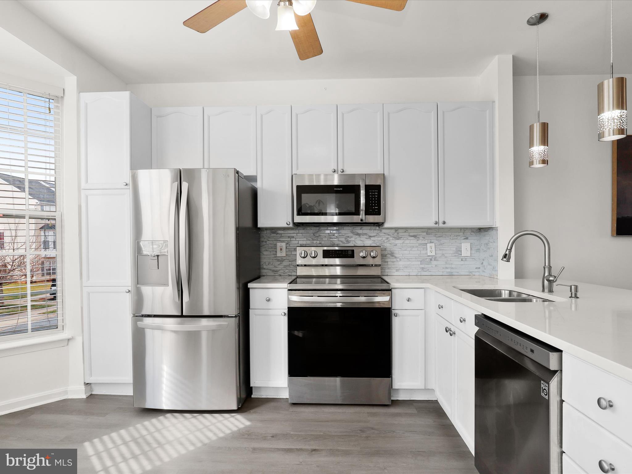 174 Harpers Way Frederick, MD 21702 - Photo 10 of 56 a kitchen with stainless steel appliances a refrigerator sink and microwave