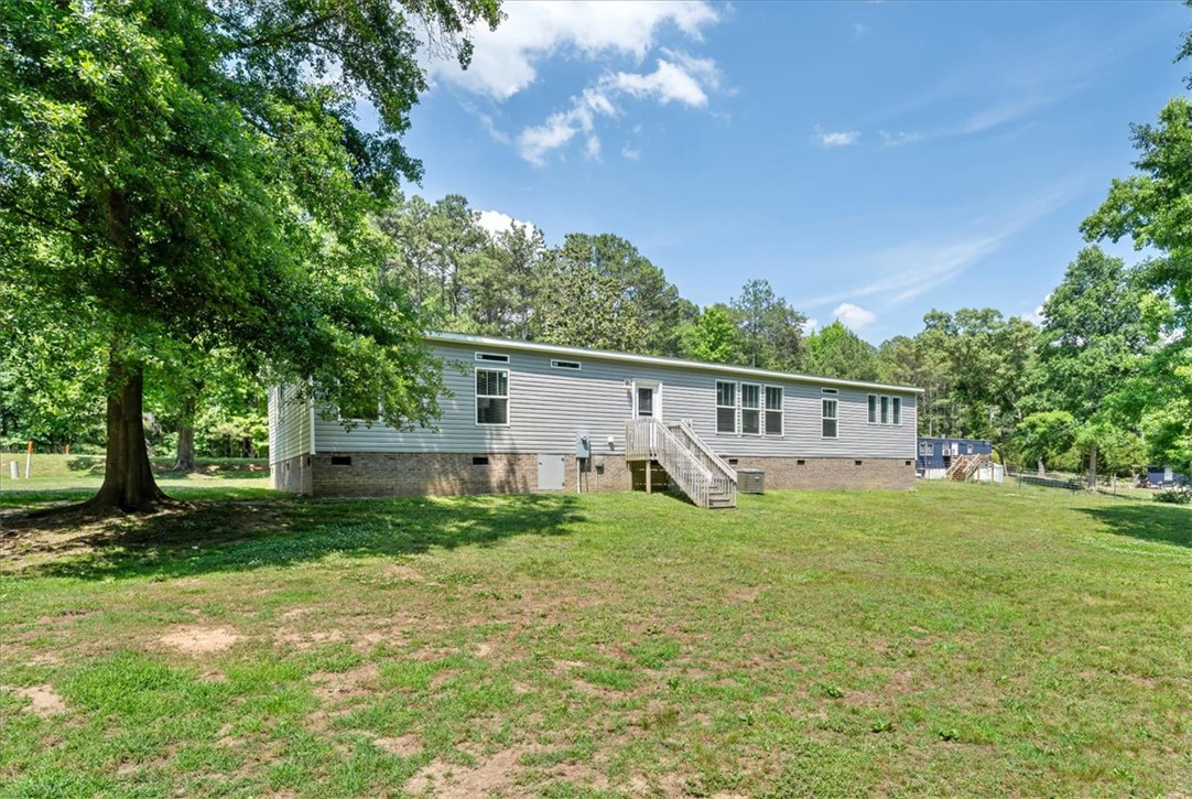 116 Parkview Road Iva, SC 29655 - Photo 40 of 44 A sprawling green lawn envelops this residence, set against a backdrop of mature shade trees.