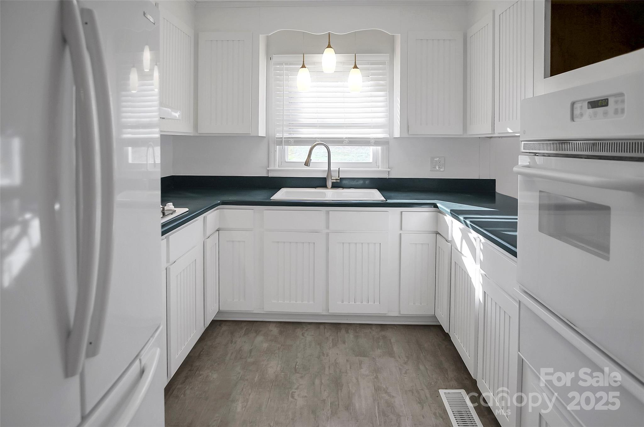1925 Montclair Avenue Gastonia, NC 28054 - Photo 11 of 35 a kitchen with white cabinets and sink