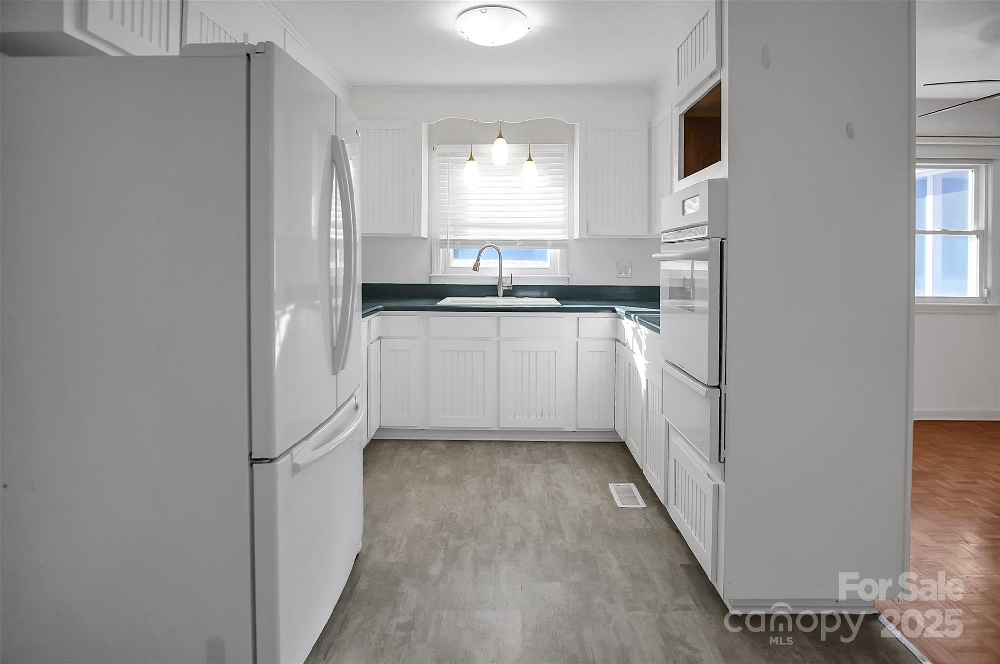 1925 Montclair Avenue Gastonia, NC 28054 - Photo 12 of 35 a kitchen with stainless steel appliances granite countertop a sink and a refrigerator