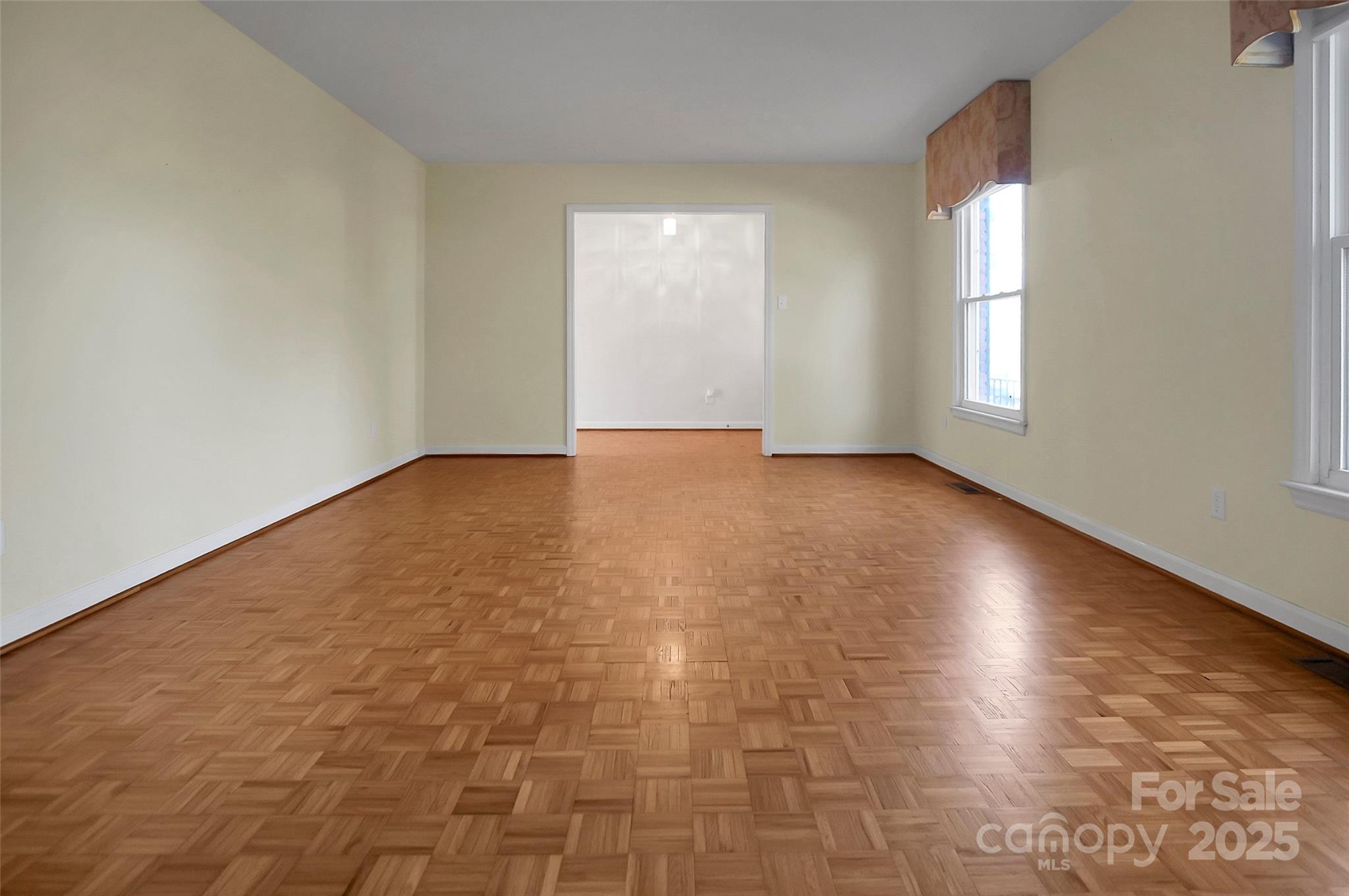1925 Montclair Avenue Gastonia, NC 28054 - Photo 17 of 35 an empty room with wooden floor and windows in it