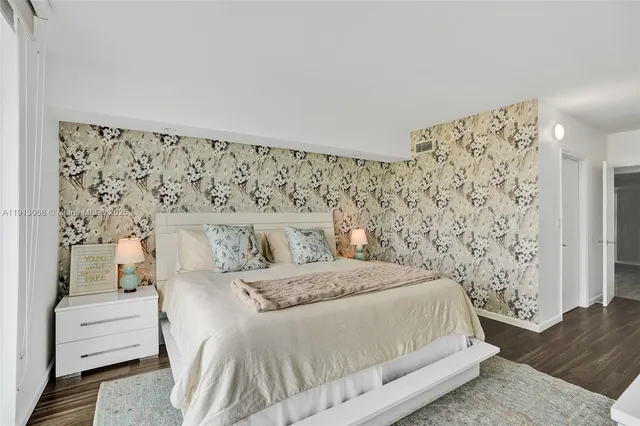 a living room with furniture and view of kitchen