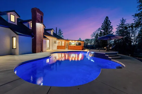 an aerial view of a house with yard swimming pool and outdoor seating