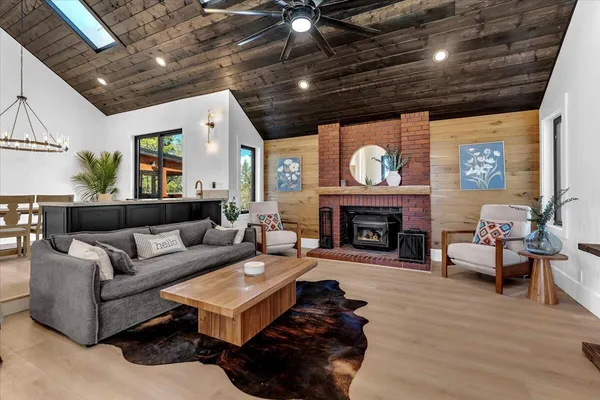 a living room with furniture a fireplace and a potted plant
