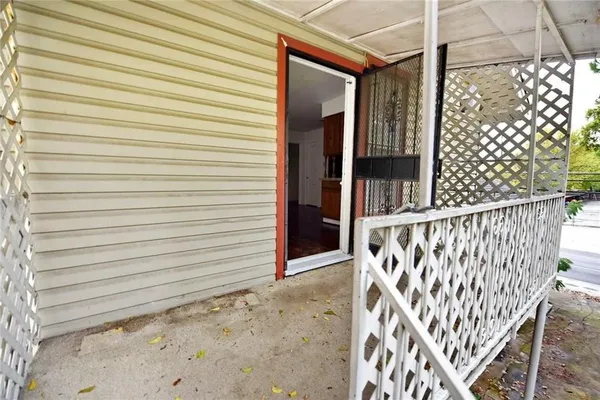 a view of a house with a wooden deck