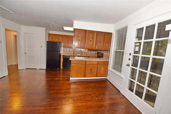 a kitchen with stainless steel appliances a refrigerator and wooden floor