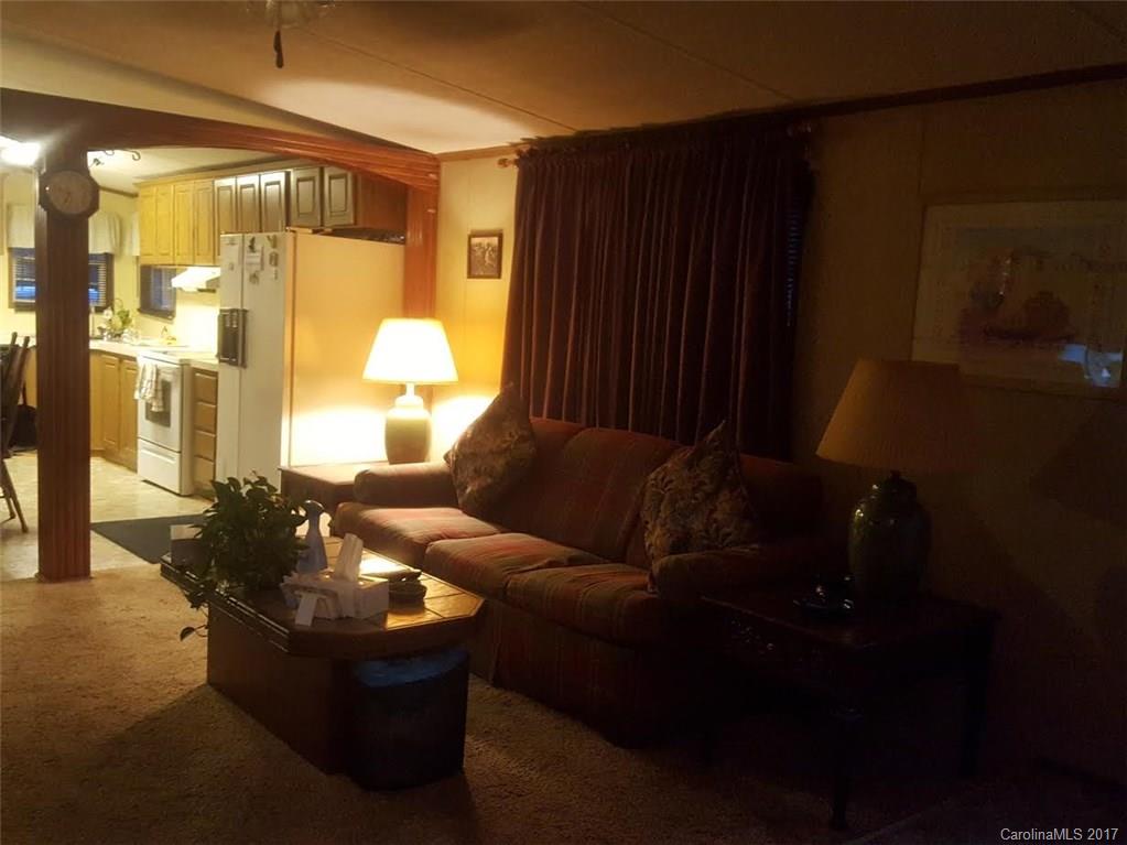 46 Austin Road, Unit 3 Clyde, NC 28721 - Photo 4 of 13 a living room with furniture and a chandelier