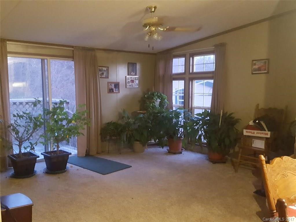 46 Austin Road, Unit 3 Clyde, NC 28721 - Photo 5 of 13 a living room with furniture potted plant and windows
