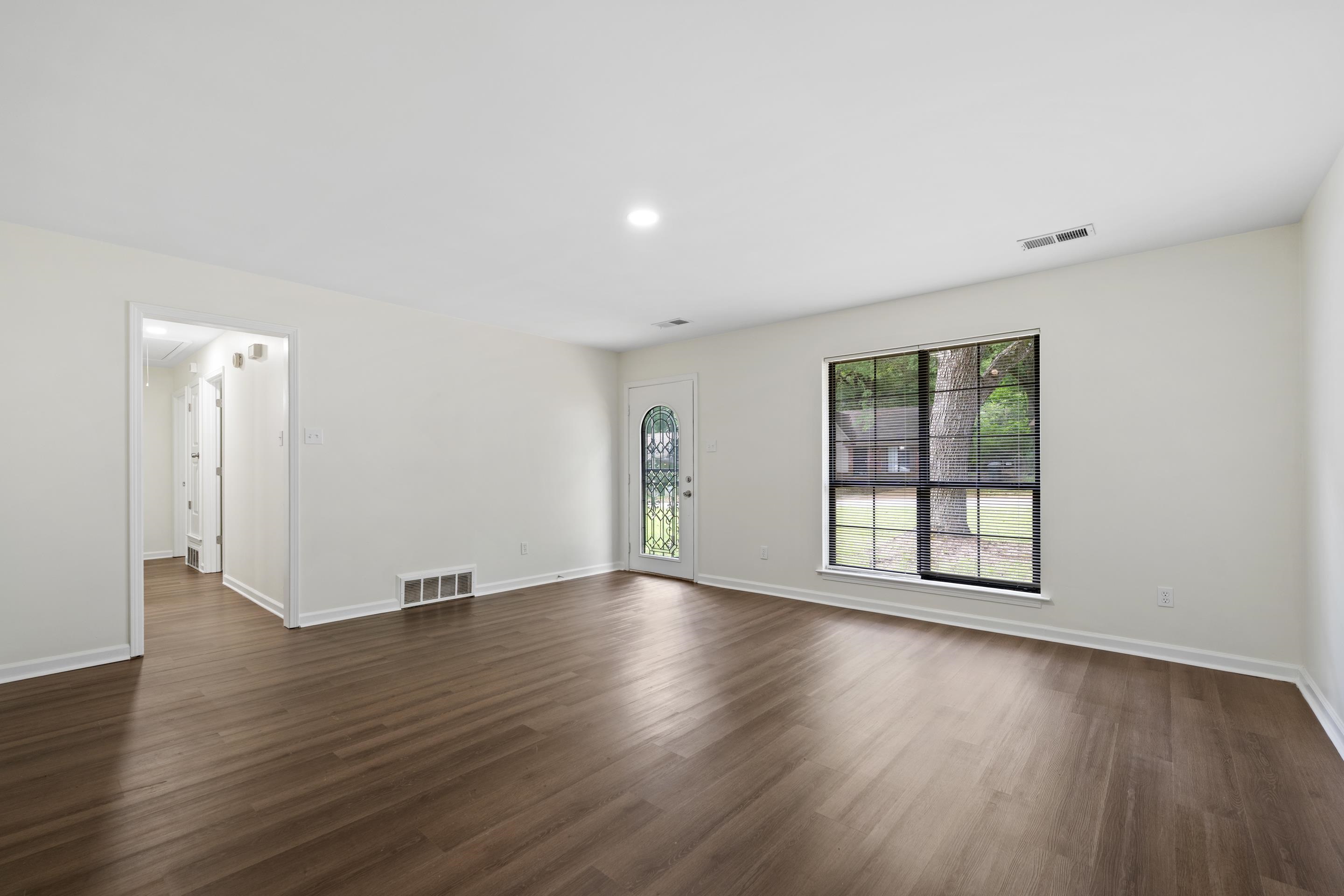 6400 Saginaw Road Memphis, TN 38134 - Photo 8 of 27 Wide-open great room showcasing the home's spacious layout, updated flooring, fresh paint, and endless possibilities for furniture placement.